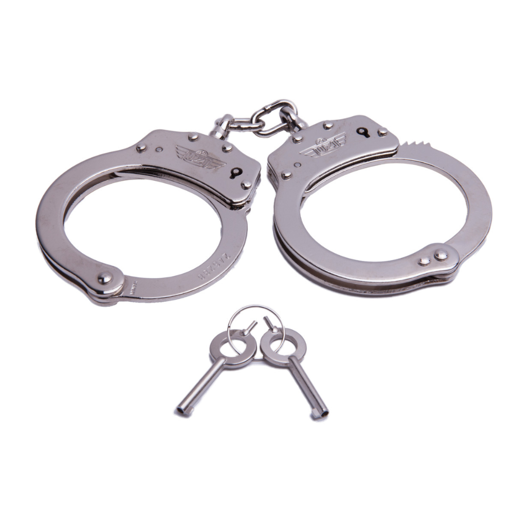 Metallic handcuffs with two keys on a white background