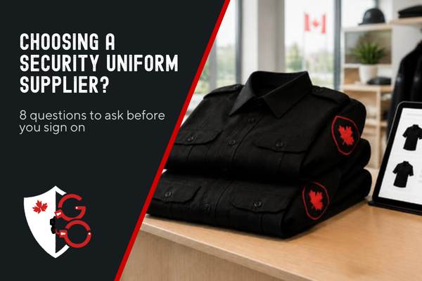 Crested black security uniform shirts, epaulettes and a tablet showing an online B2B ordering portal on a store counter