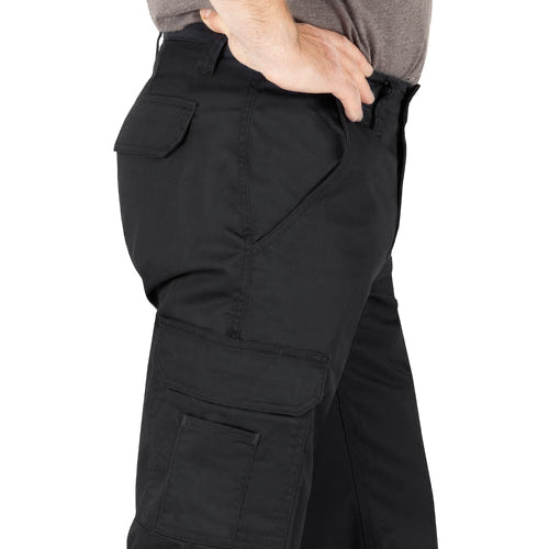 Close-up side view of man wearing black cargo work pants, showing hip pocket, waistband, and cargo pocket with flap closure